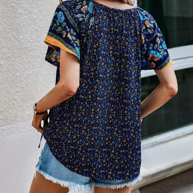 Deze blouse combineert een verfijnde V-hals met een levendige bloemenprint, ideaal voor warme dagen en zwoele avonden.