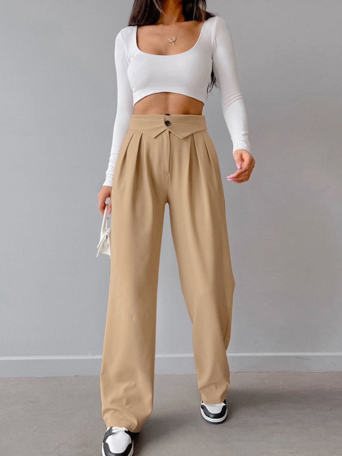 Deze broek is ontworpen voor een moeiteloos chique look, met zijn wijde pijpen en omgevouwen tailleband die een trendy touch toevoegen aan je outfit.