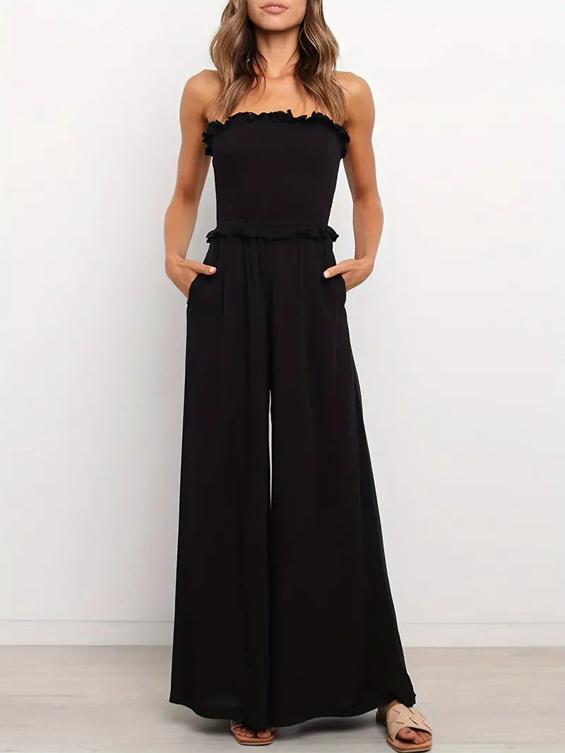 Model draagt zwarte Zwarte Cold-shoulder Jumpsuit off shlouder gebroken schouden open blote schouders broek met wijde pijp